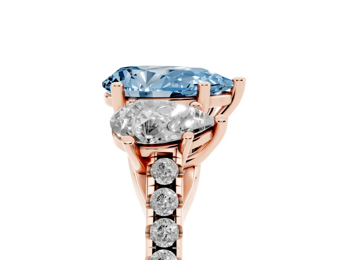 Fancy Blue Three-Stone Pear Cut Diamond Ring with Round Pavé Band and Prong Setting Rose gold