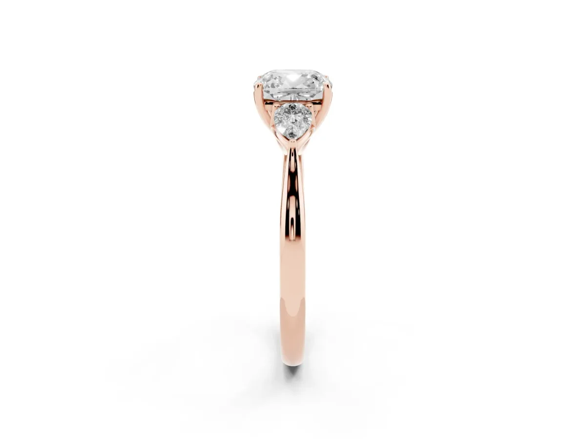 Three-Stone Cushion Cut Diamond Ring with Pear Side Stones in Four-Prong Setting Rose gold