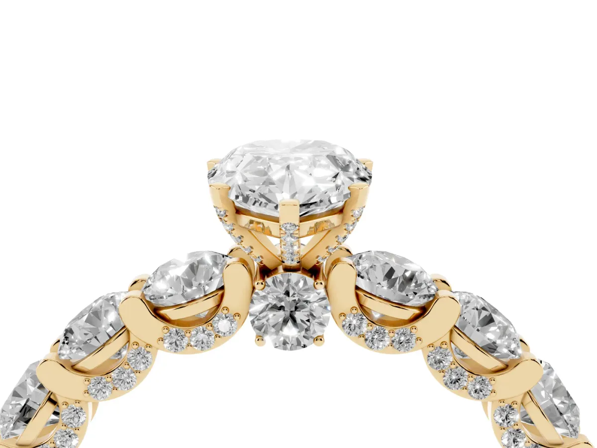 Pear Cut Diamond Side Stone Engagement Ring with Four-Prong Setting Yellow gold