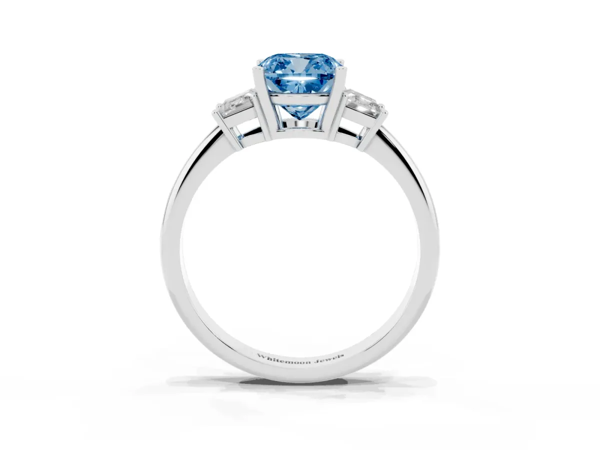 Fancy Blue Cushion Cut Diamond Three-Stone Ring with Trapezoid Side Stones and Prong Setting Platinum
