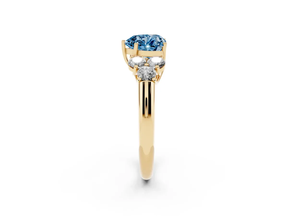 Fancy Blue Heart Cut Cut Diamond Cluster Ring with Round Accent Stones and Prong Setting on a Classic Band Yellow gold