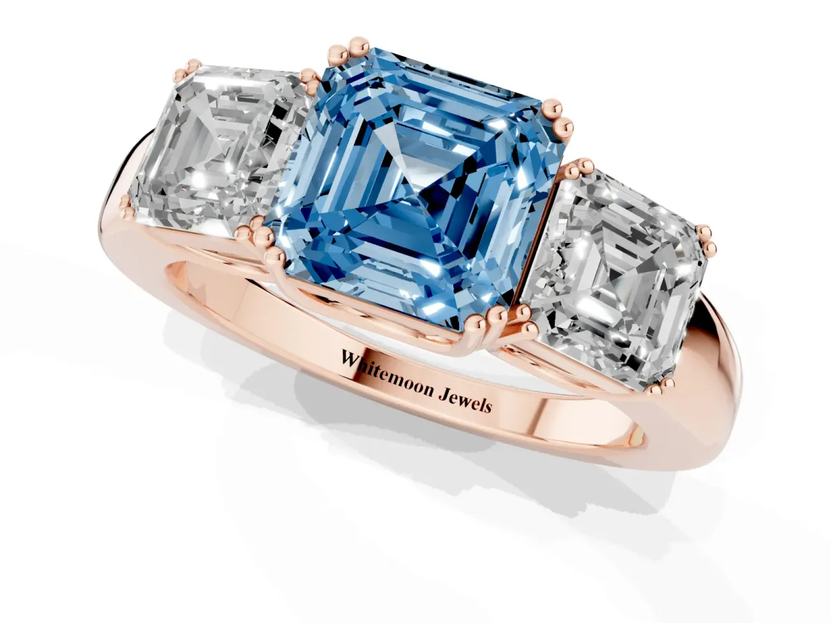 Fancy Blue Three-Stone Asscher Cut Cut Diamond Ring with Channel Set Band and Four-Prong Setting Rose gold