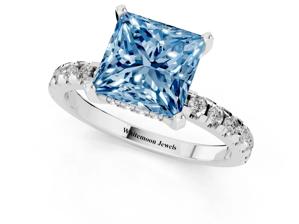 Fancy Blue Princess Cut Diamond Solitaire Ring with Round Pavé Band and Four-Prong Setting Silver