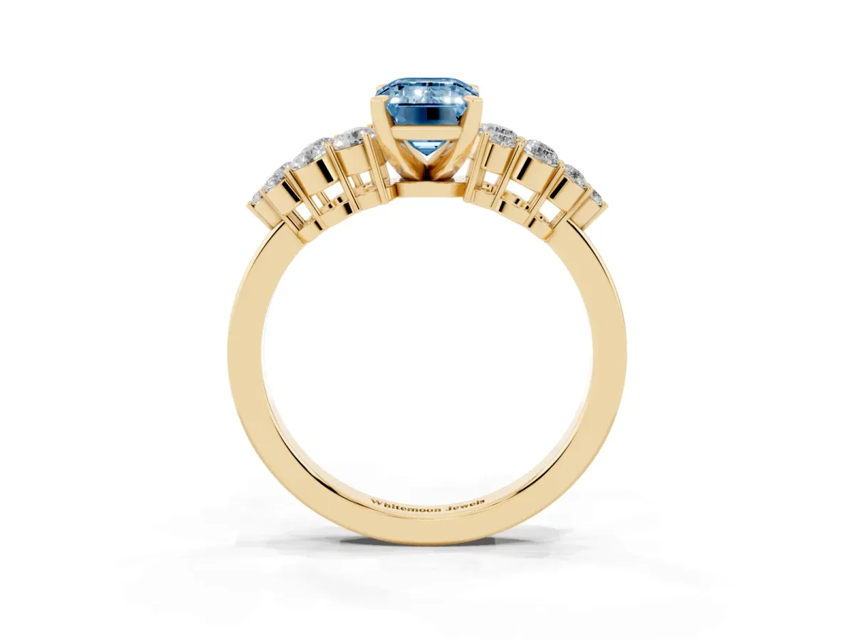 Fancy Blue Emerald Cut Cluster Diamond Engagement Ring with Pavé Band and Four-Prong Setting Yellow gold