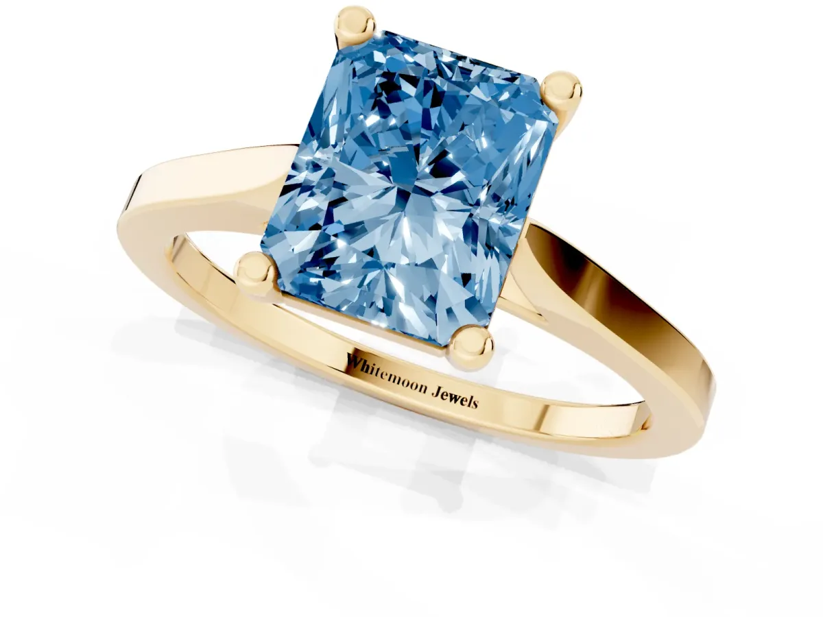 Fancy Blue Radiant Cut Solitaire Diamond Ring with Four-Prong Setting and Tapered Band Yellow gold