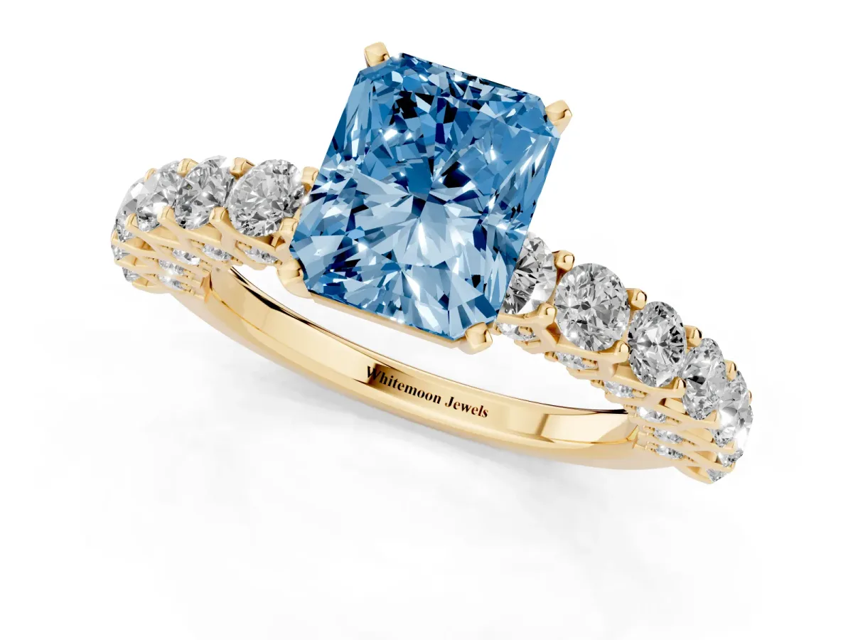 Fancy Blue Radiant Cut Diamond Solitaire Ring with Shared Prong Pavé Band and Four-Prong Setting Yellow gold