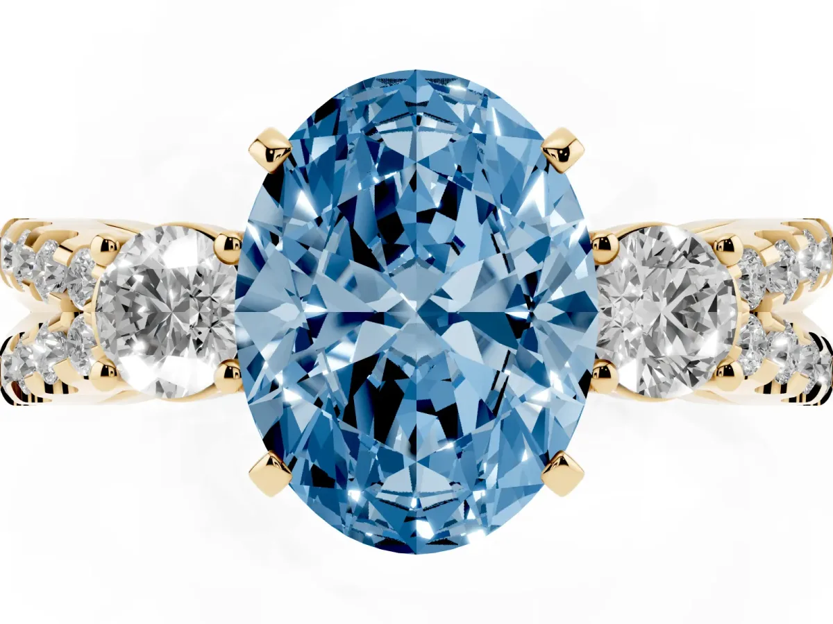 Fancy Blue Oval Cut Diamond Three-Stone Ring with Pavé Split Shank and Four-Prong Setting Yellow gold