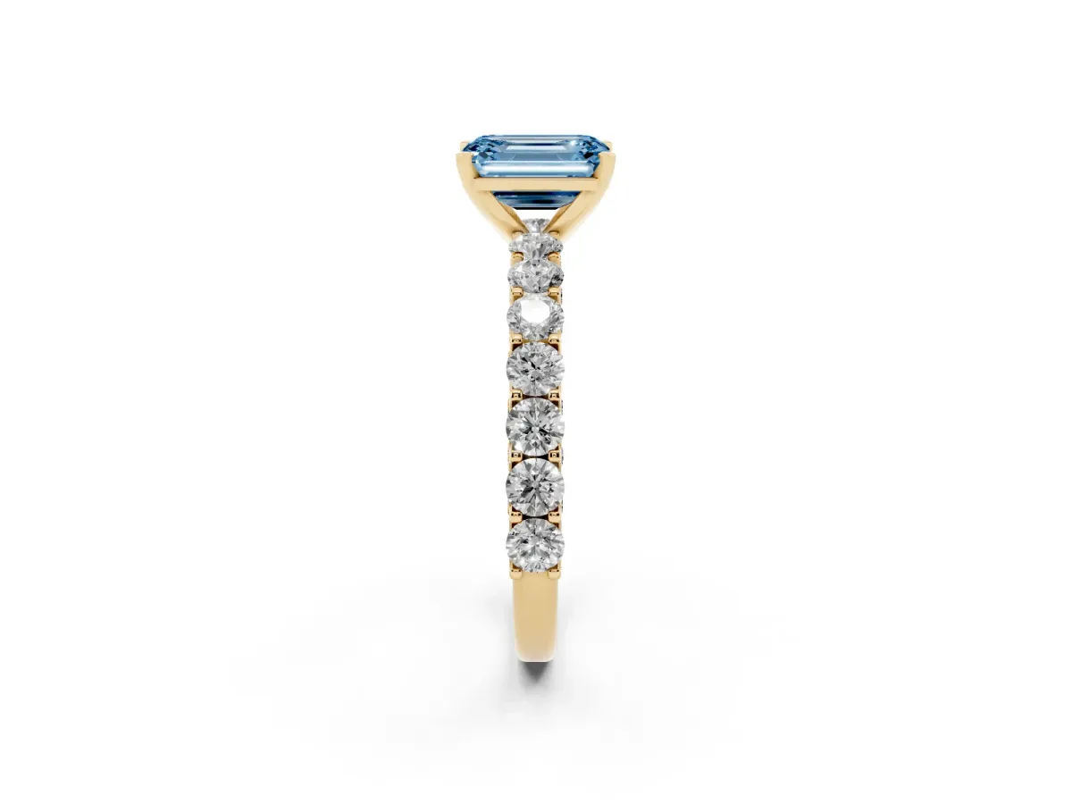 Fancy Blue Emerald Cut Diamond Solitaire Ring with Shared Prong Pavé Band and Four-Prong Setting Yellow gold