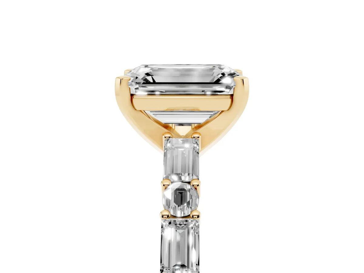 Emerald Cut Diamond Solitaire with Side Baguettes and Channel Set Band Yellow gold