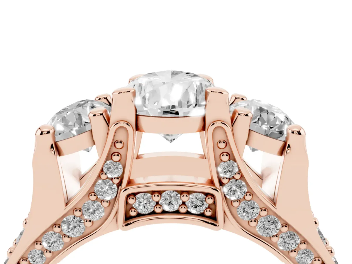 Pear Cut Diamond Three-Stone Ring with Channel Set Band and Four-Prong Setting Rose gold