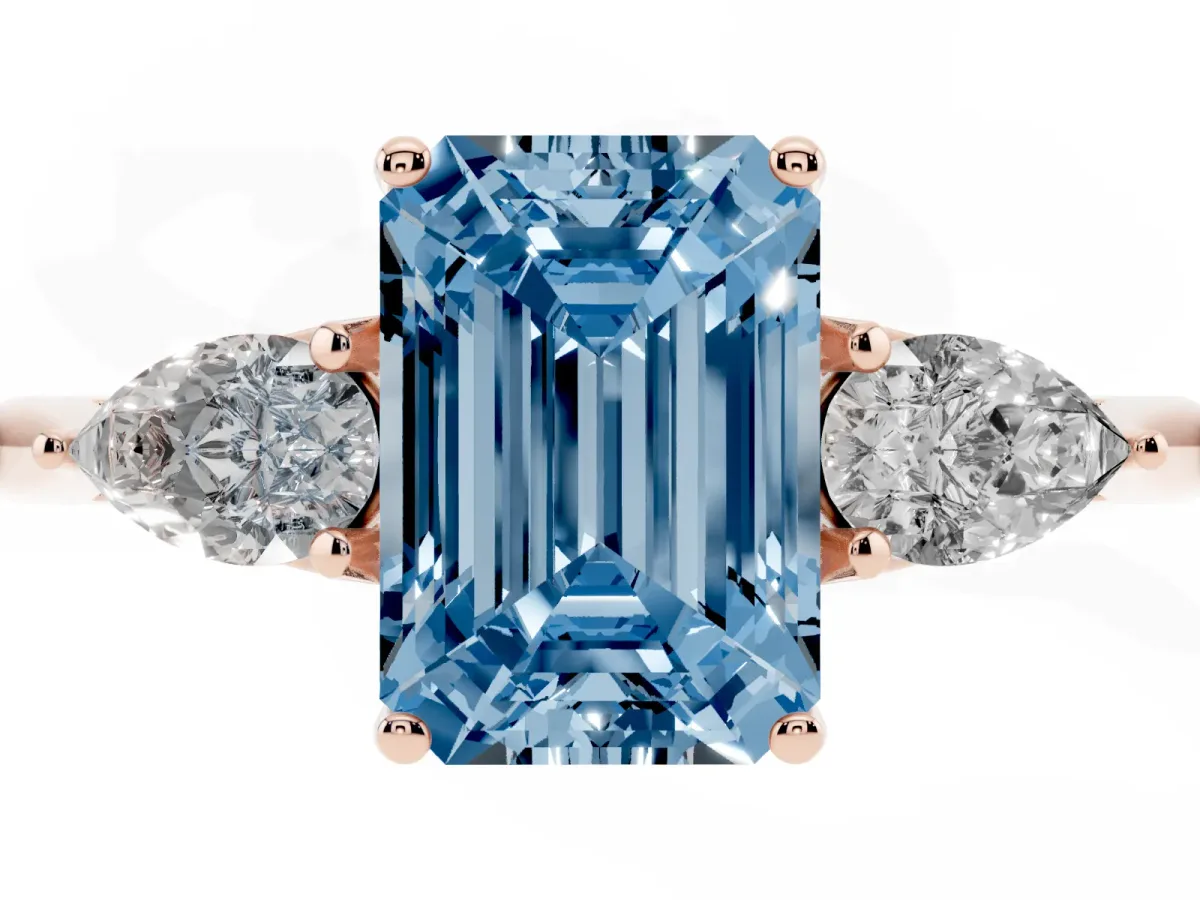 Fancy Blue Three-Stone Emerald Cut Diamond Ring with Pear Side Stones in Four-Prong Setting Rose gold
