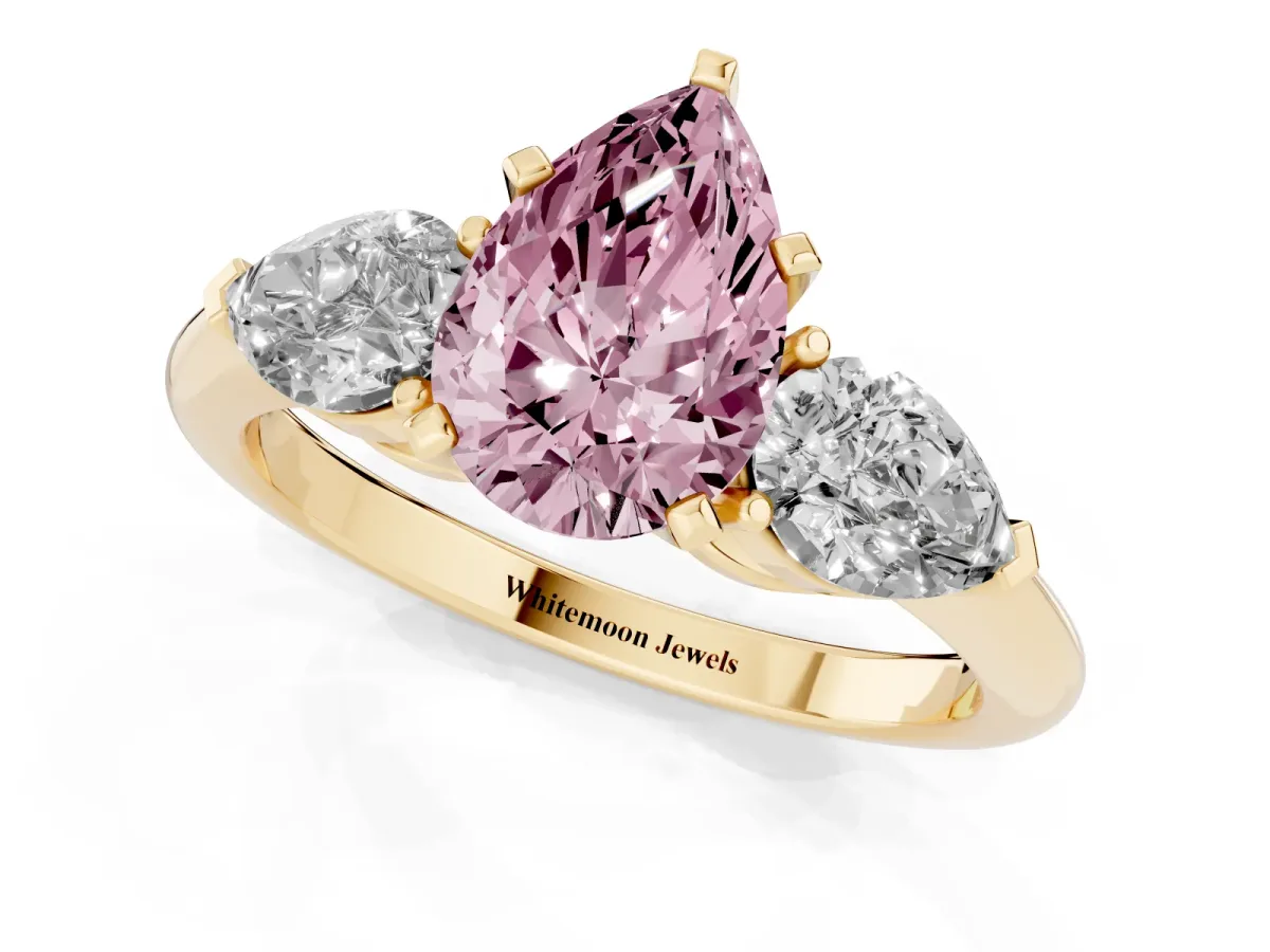 Fancy Pink Three-Stone Pear Cut Diamond Ring with Pear Side Stones and Four-Prong Setting Yellow gold