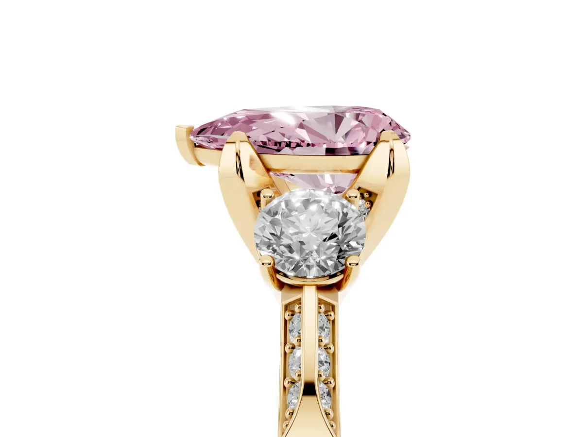 Fancy Pink Pear Cut Brilliant Three-Stone Diamond Ring with Pavé Band and Four-Prong Setting Yellow gold