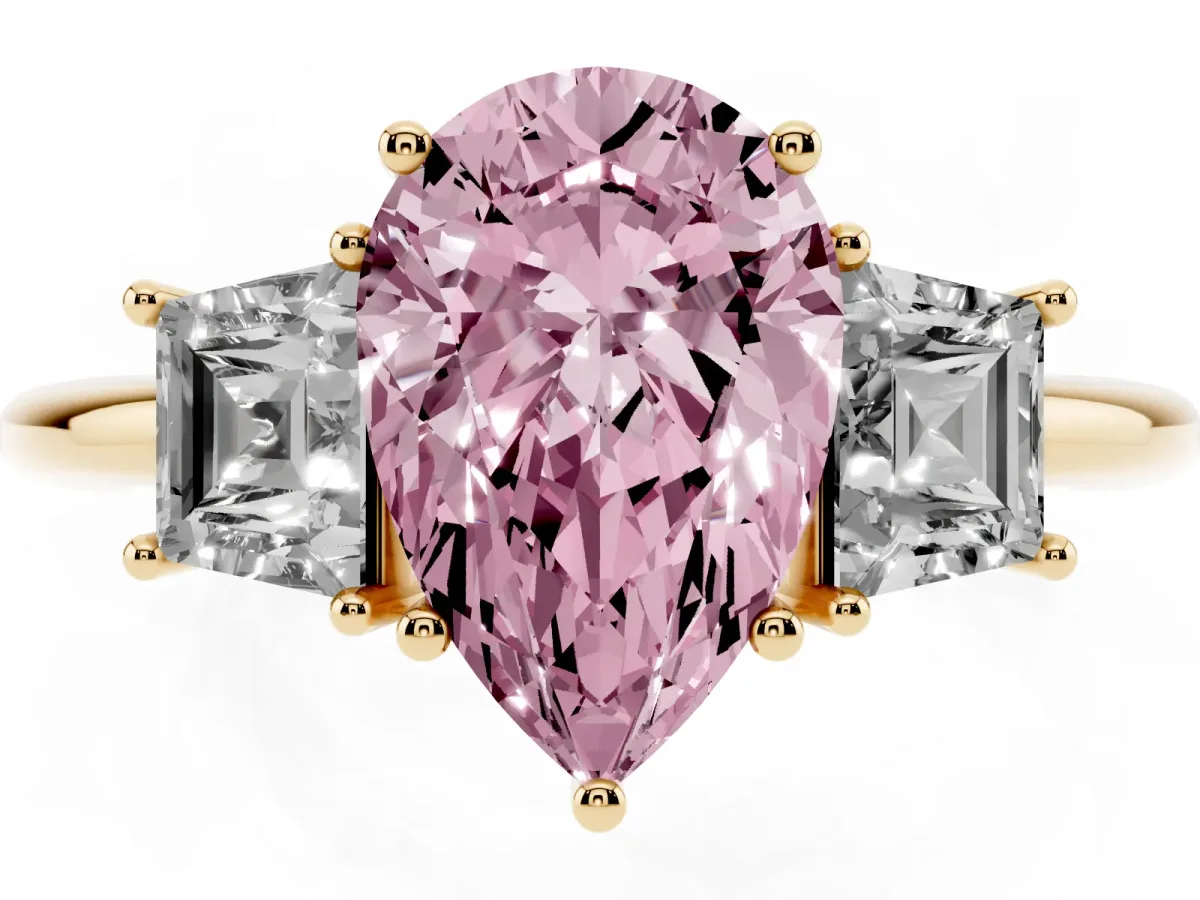 Fancy Pink Pear Cut Diamond Three-Stone Ring with Trapezoid Side Stones and Prong Setting Yellow gold