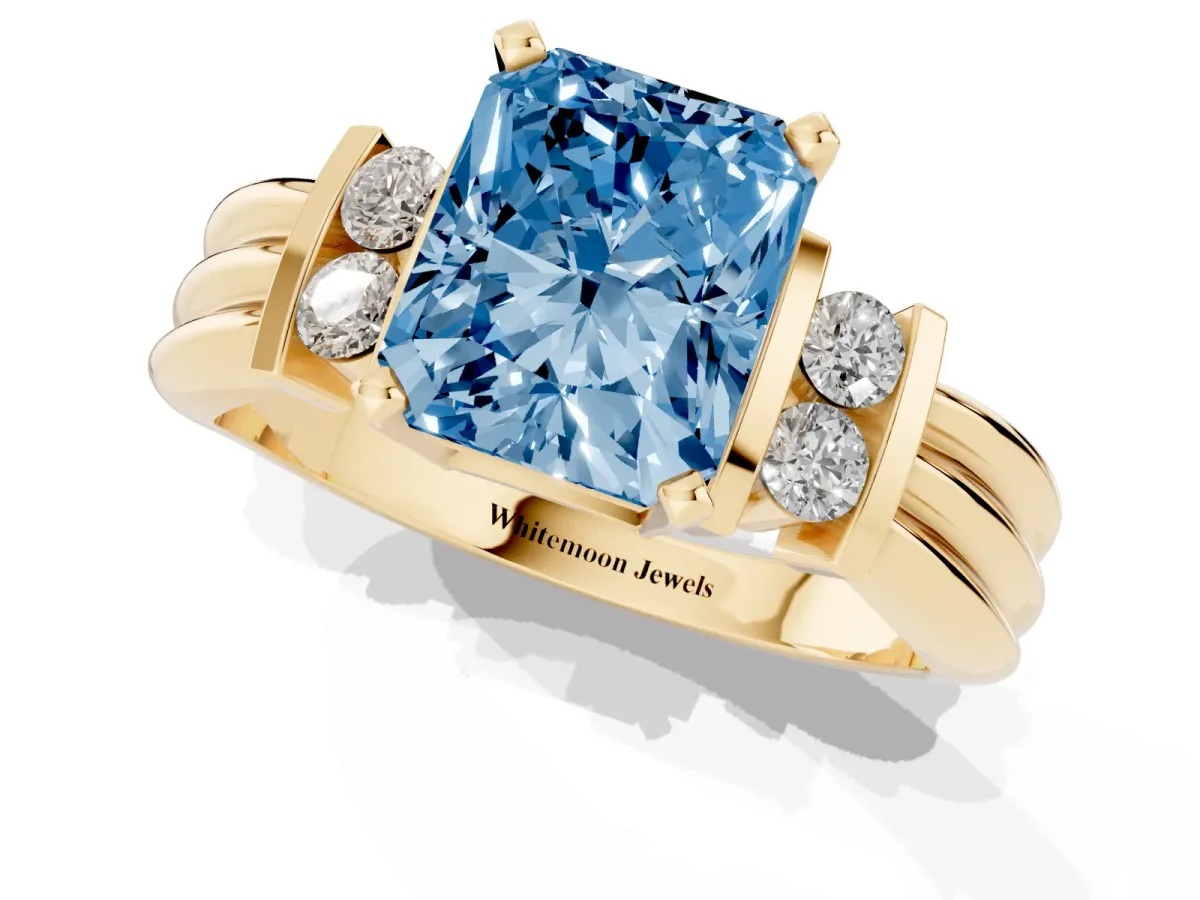Fancy Blue Radiant Cut Cut Three-Stone Channel Set Ring with Bar Prongs Yellow gold