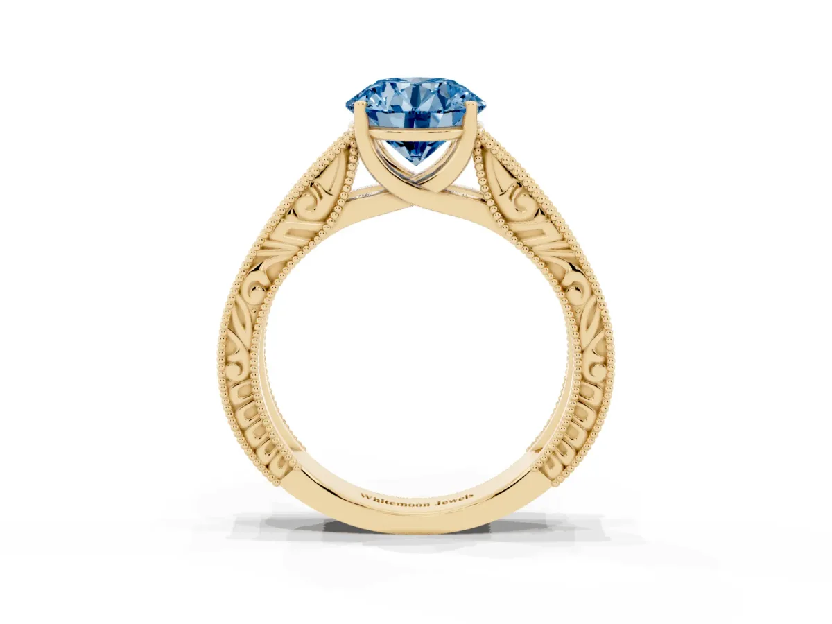 Fancy Blue Round Cut Diamond Solitaire Ring with Engraved Band and Four-Prong Setting Yellow gold