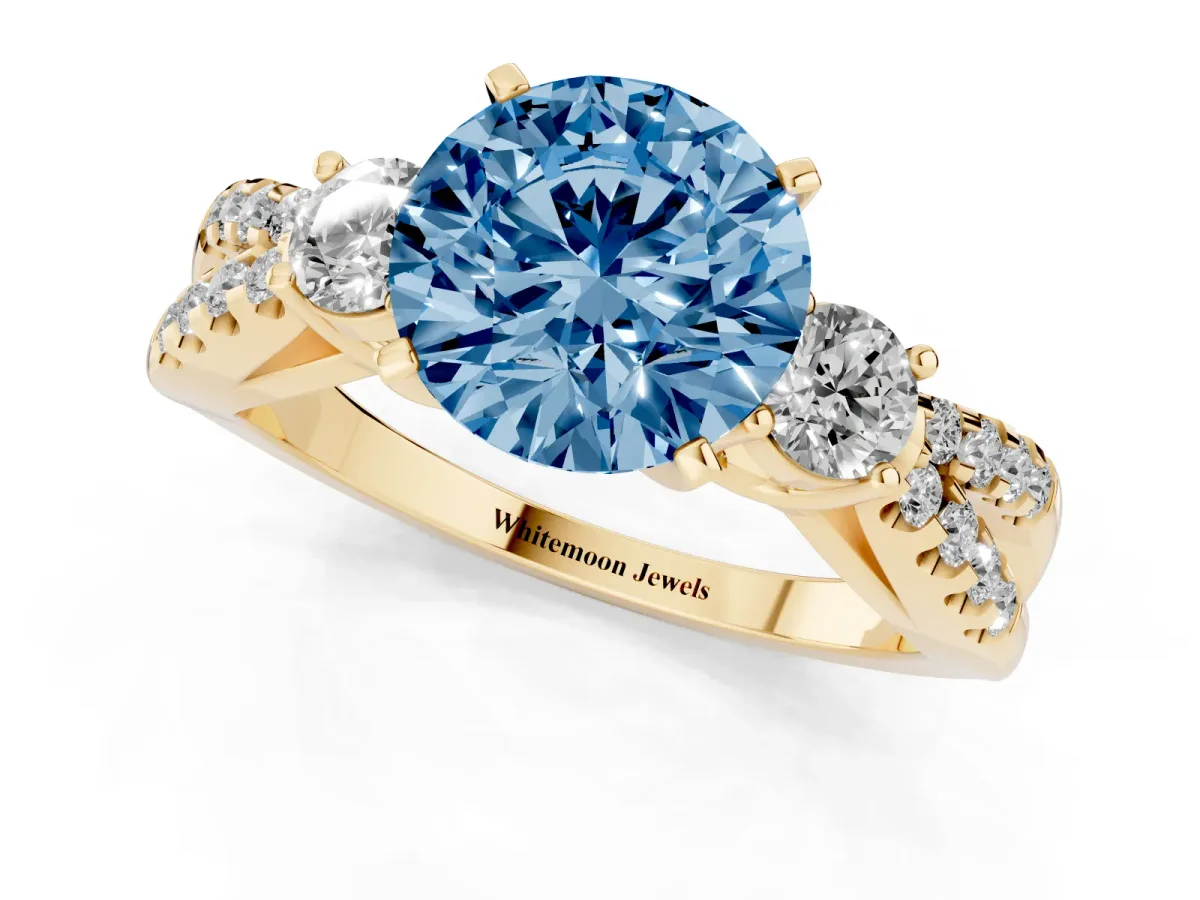 Fancy Blue Round Cut Diamond Three-Stone Ring with Pavé Split Shank and Four-Prong Setting Yellow gold