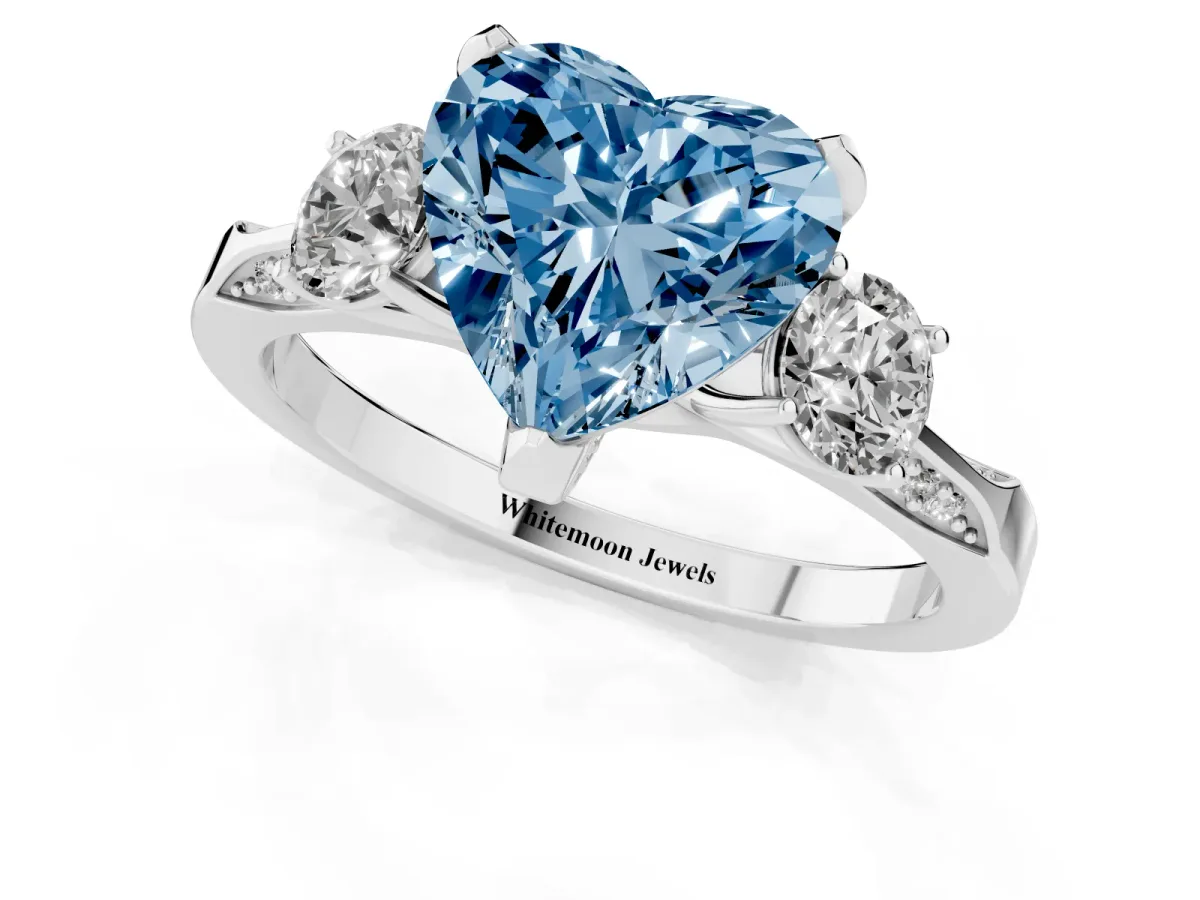 Fancy Blue Heart Cut Brilliant Three-Stone Diamond Ring with Pavé Band and Four-Prong Setting Platinum