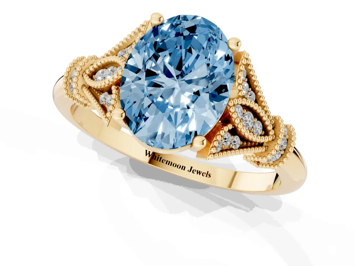 Fancy Blue Oval Cut Diamond Solitaire Ring with Floral Filigree and Pave Accents Yellow gold