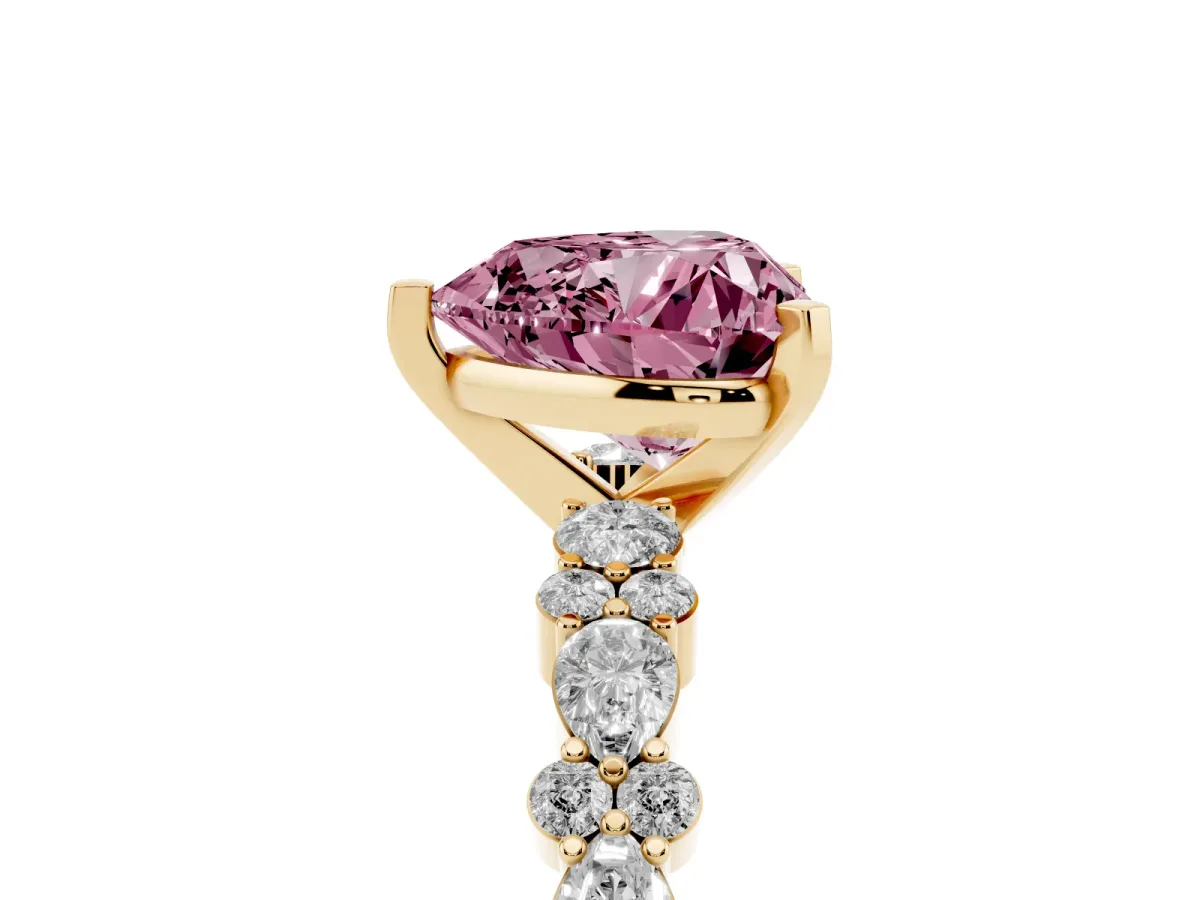 Fancy Pink Heart Cut Diamond Side Stone Solitaire Ring with Round and Four-Prong Setting Yellow gold