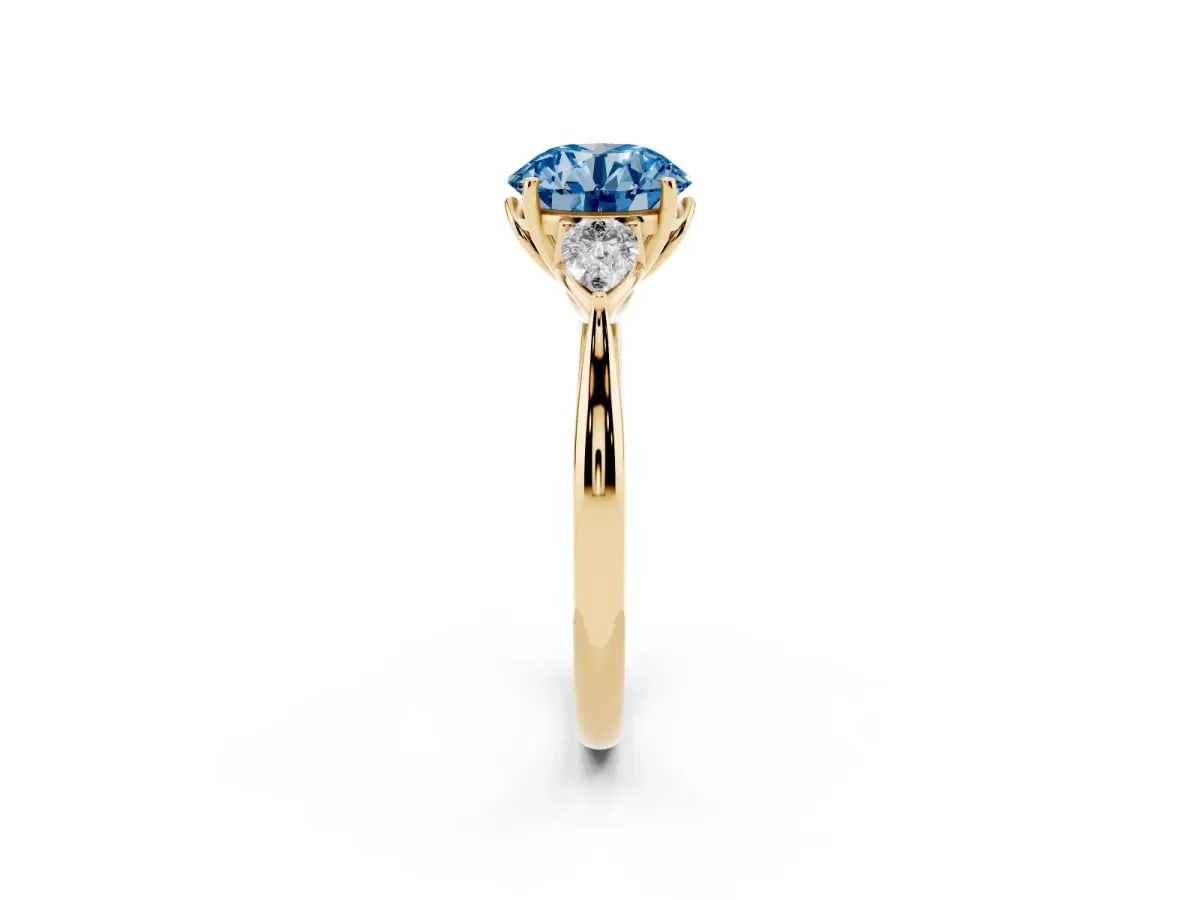 Fancy Blue Round Cut Diamond Three-Stone Ring with Pear Side Stones and Prong Setting Yellow gold