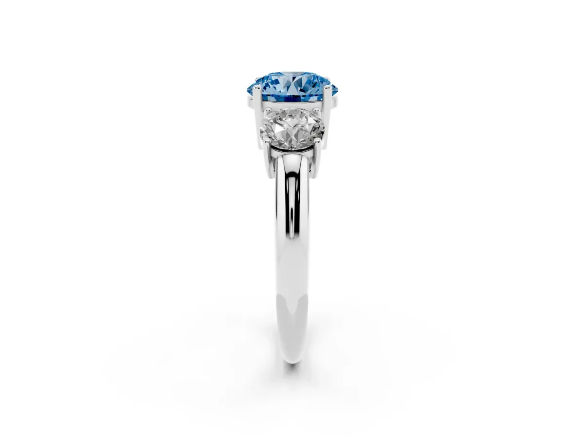 Fancy Blue Three-Stone Round Cut Cut Diamond Engagement Ring with Prong Setting on a White Gold Band Platinum