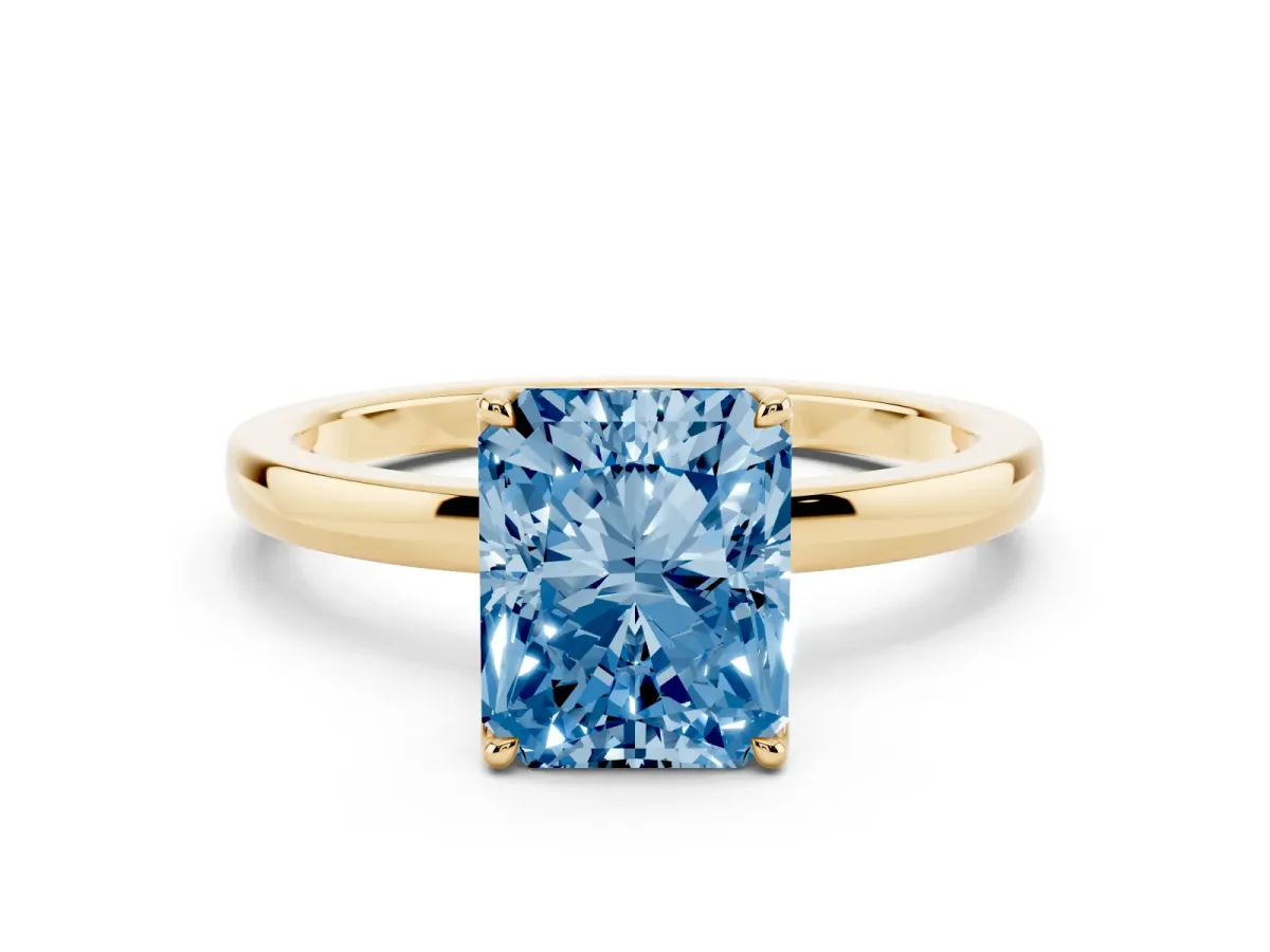 Fancy Blue Radiant Cut Diamond Solitaire Ring with Thin Band and Prong Setting Yellow gold