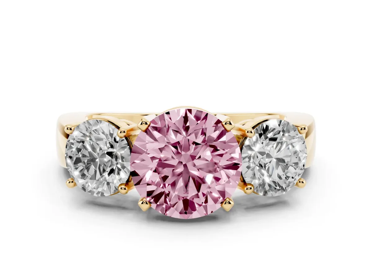 Fancy Pink Three-Stone Round Cut Diamond Ring with Round Side Stones, Classic Band, and Four-Prong Setting Yellow gold