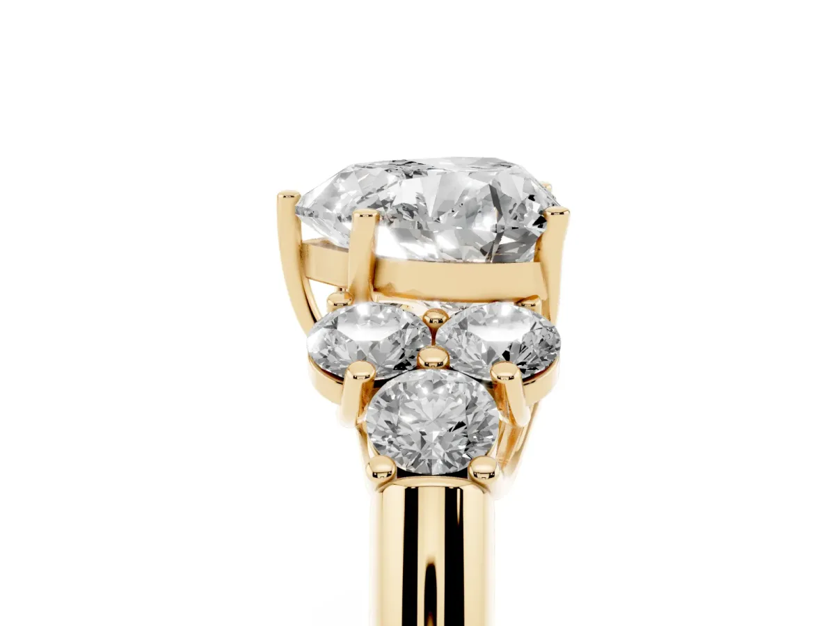 Heart Cut Cut Diamond Cluster Ring with Round Accent Stones and Prong Setting on a Classic Band Yellow gold
