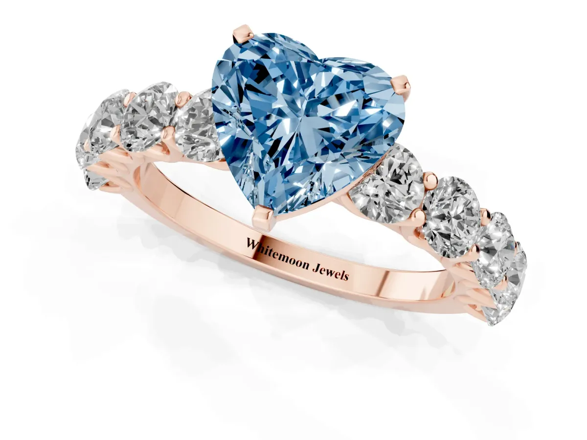 Fancy Blue Heart Cut Diamond Prong Setting with Side Stones on a Pave Band Rose gold