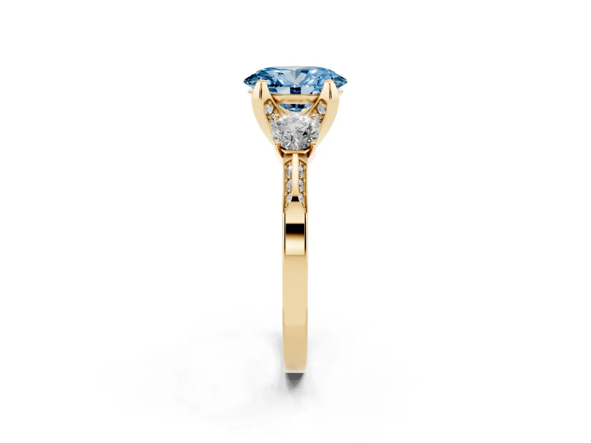 Fancy Blue Oval Cut Brilliant Three-Stone Diamond Ring with Pavé Band and Four-Prong Setting Yellow gold