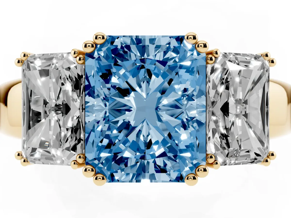 Fancy Blue Three-Stone Radiant Cut Cut Diamond Ring with Channel Set Band and Four-Prong Setting Yellow gold