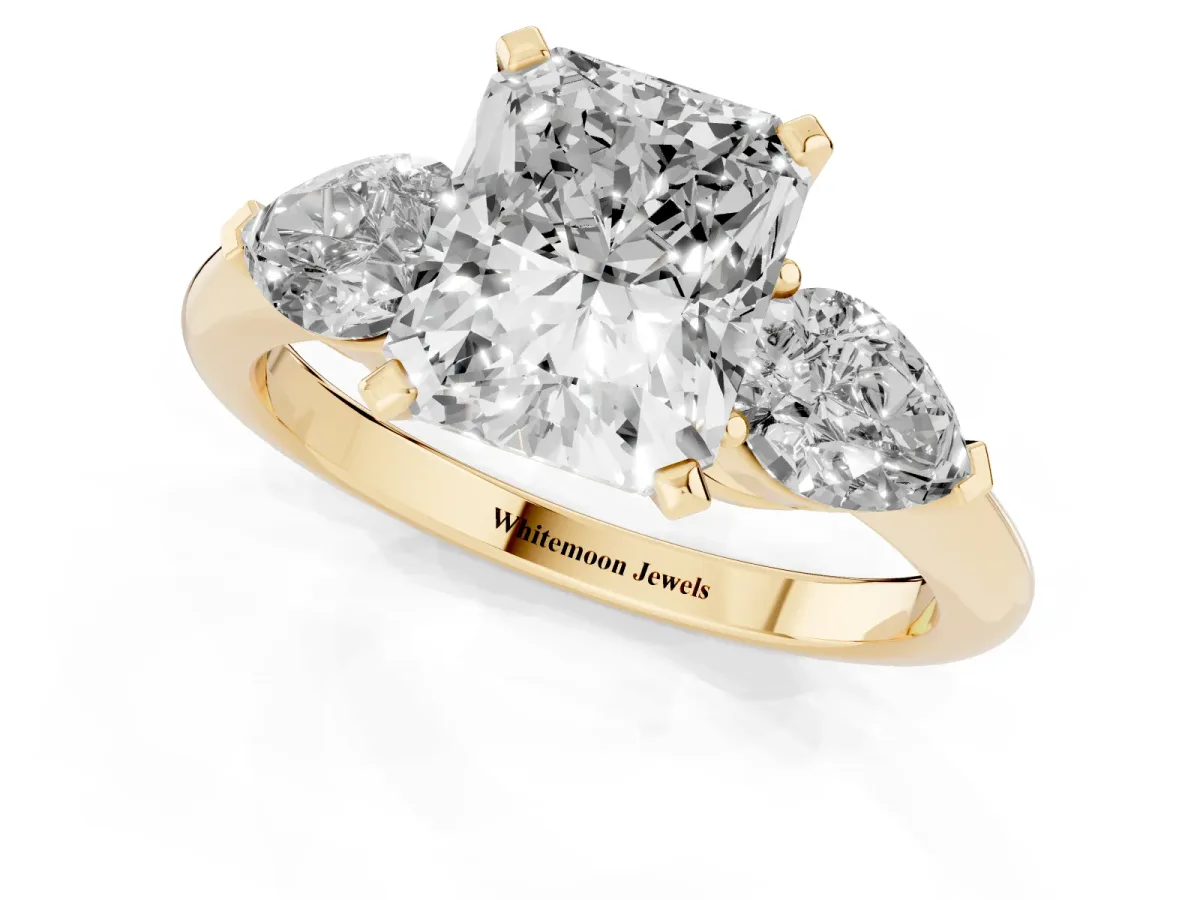 Three-Stone Radiant Cut Diamond Ring with Pear Side Stones and Four-Prong Setting Yellow gold