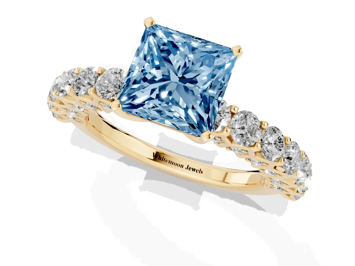 Fancy Blue Princess Cut Diamond Solitaire Ring with Shared Prong Pavé Band and Four-Prong Setting Yellow gold