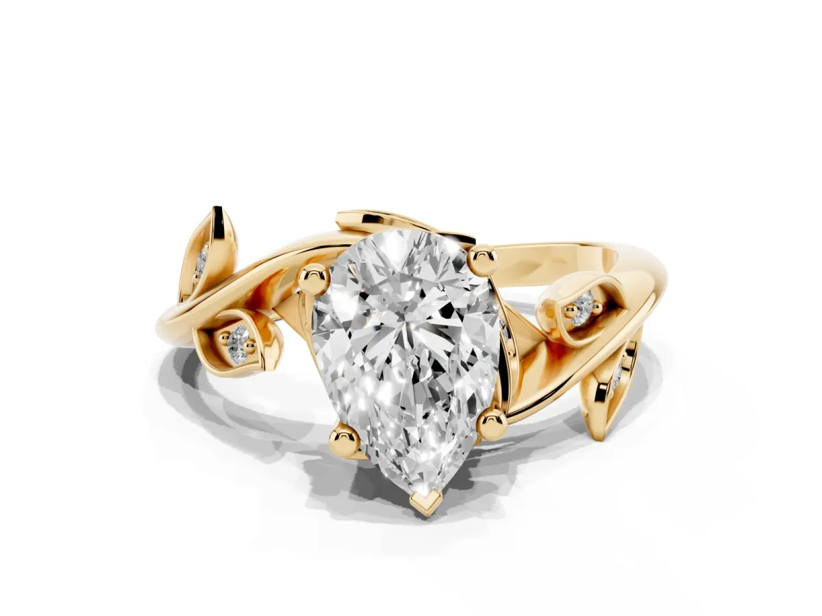 Pear Cut Solitaire Twist Engagement Ring with Leaf Accents and Prong Setting Yellow gold