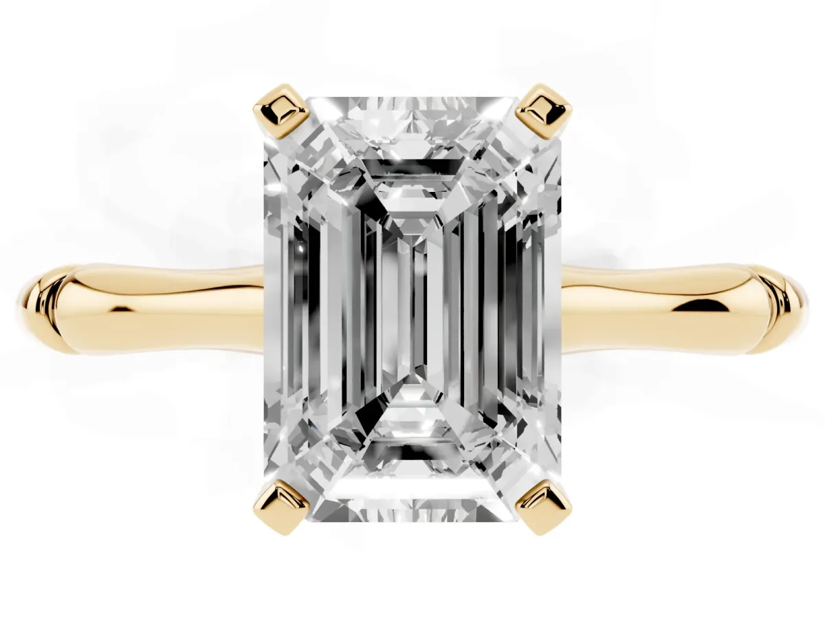 Emerald Cut Solitaire Diamond Ring with Bamboo Band and Four-Prong Setting Yellow gold