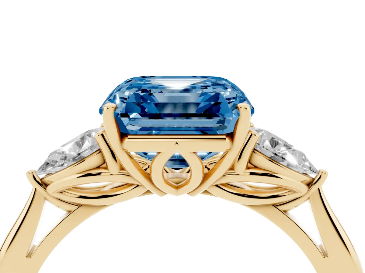 Fancy Blue Three-Stone Asscher Cut Diamond Ring with Pear Side Stones in Four-Prong Setting Yellow gold