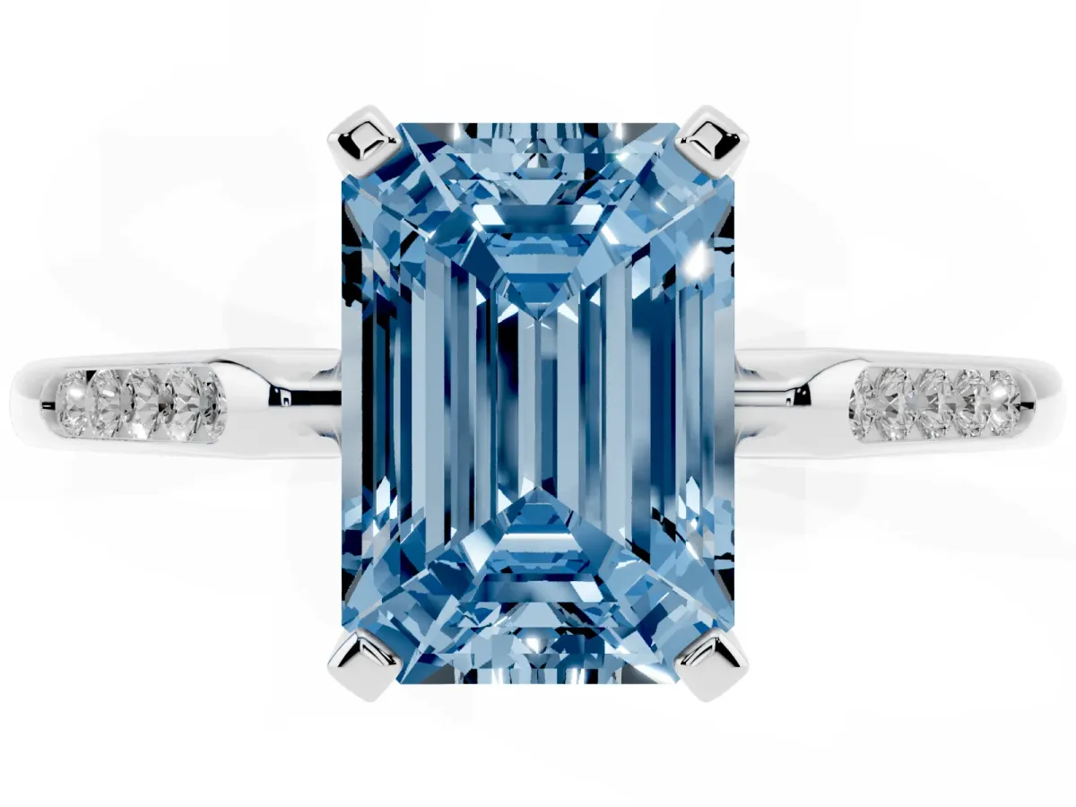 Fancy Blue Emerald Cut Diamond Solitaire Ring with Channel Set Round Band and Prong Setting Silver