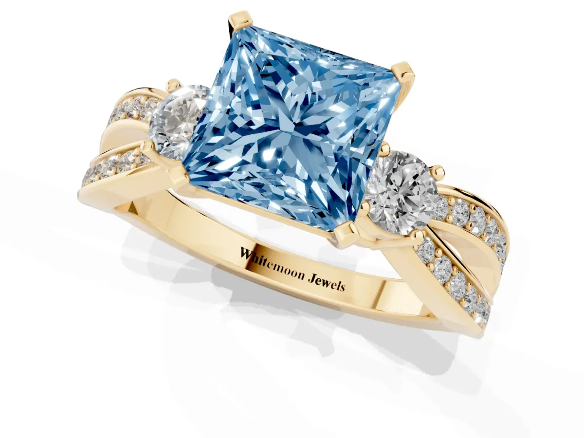 Fancy Blue Three-Stone Princess Cut Cut Diamond Twist Band with Prong Setting Yellow gold