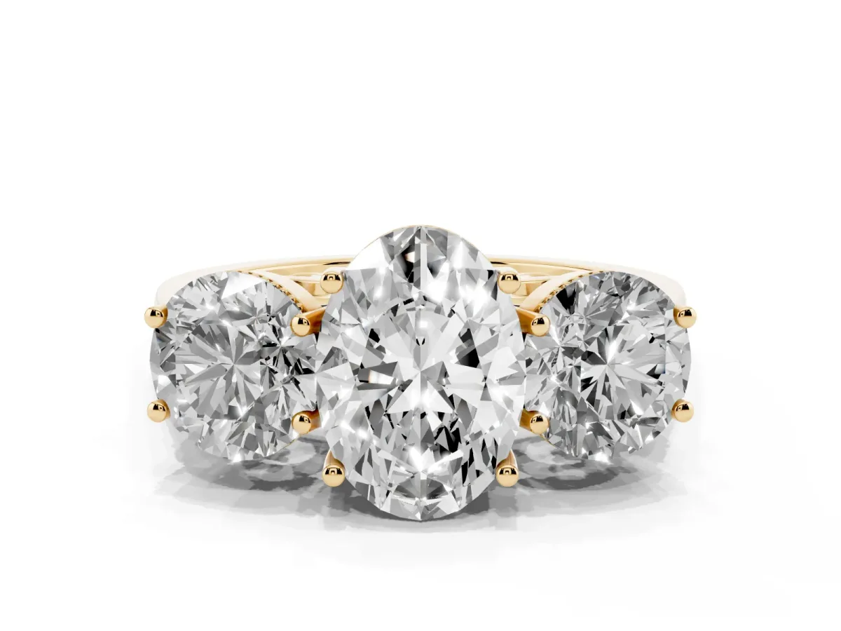 Three-Stone Oval Cut Diamond Engagement Ring with Prong Setting on a Classic Band Yellow gold