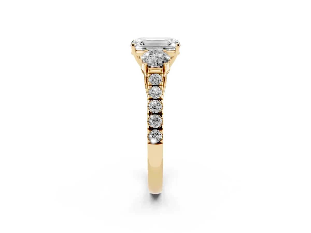 Emerald Cut Cut Diamond Three-Stone Ring with Round Side Stones and Pavé Band Yellow gold