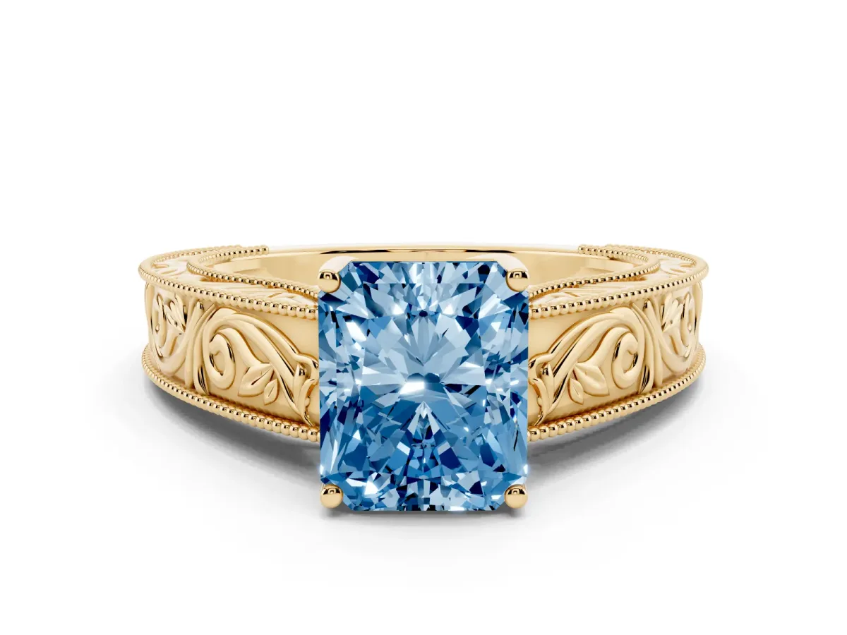 Fancy Blue Radiant Cut Diamond Solitaire Ring with Engraved Band and Four-Prong Setting Yellow gold