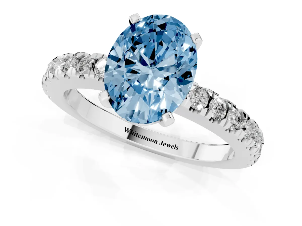 Fancy Blue Oval Cut Solitaire Diamond with Pavé Band and Four-Prong Setting Silver