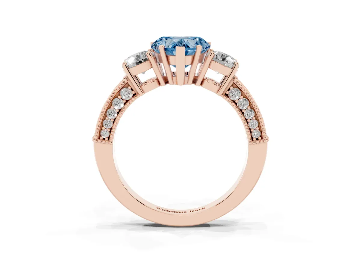 Fancy Blue Heart Cut Three-Stone Diamond Ring with Pavé Band and Four-Prong Setting Rose gold