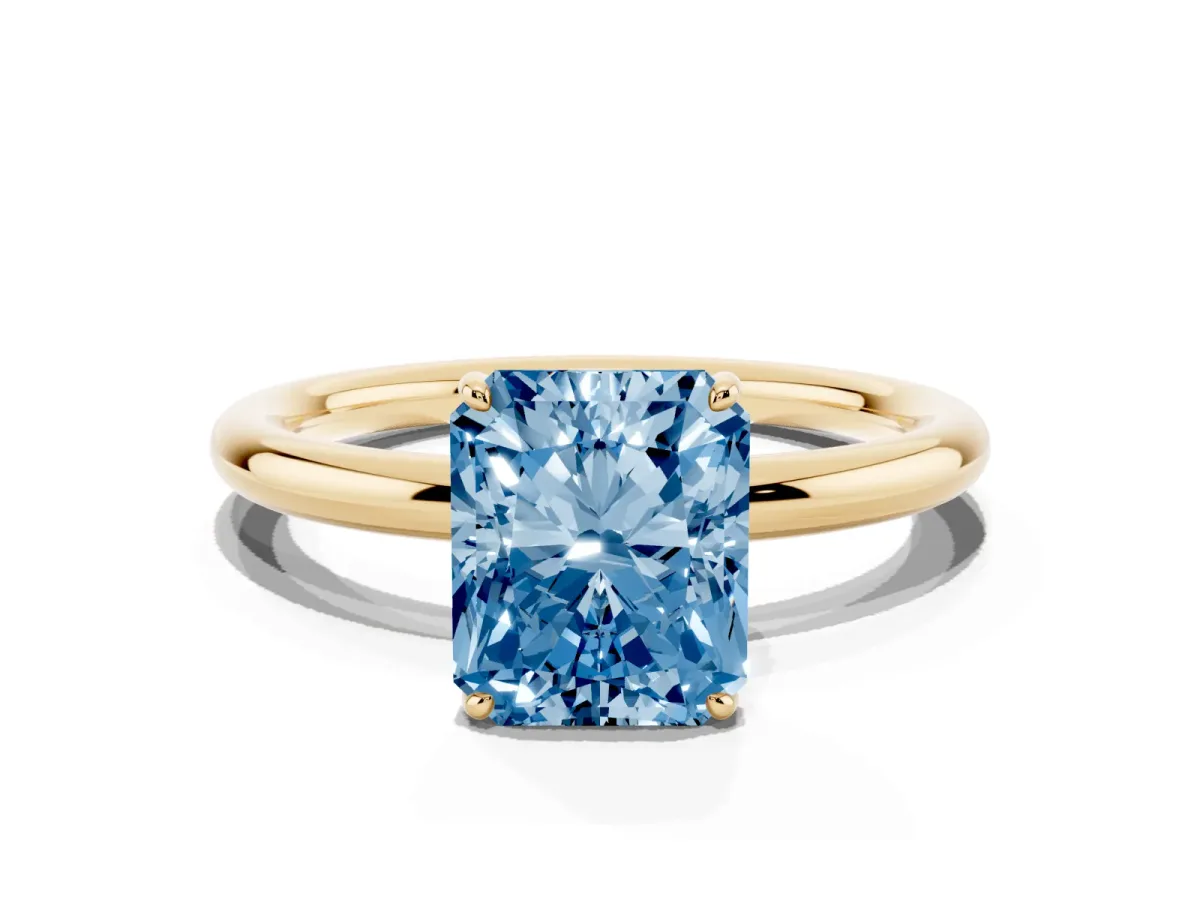 Fancy Blue Radiant Cut Solitaire Diamond Ring with Four-Prong Setting on a Plain Band Yellow gold