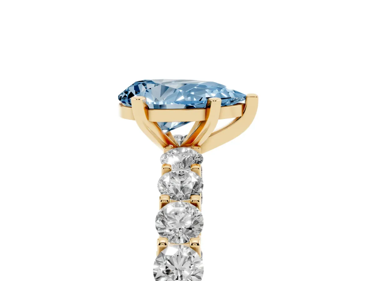 Fancy Blue Pear Cut Diamond Solitaire Ring with Shared Prong Pavé Band and Four-Prong Setting Yellow gold