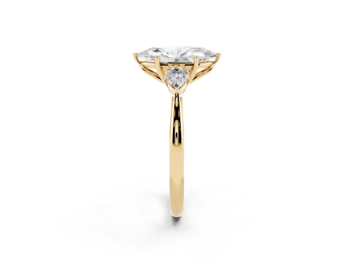 Three-Stone Marquise Cut Diamond Ring with Pear Side Stones in Four-Prong Setting Yellow gold