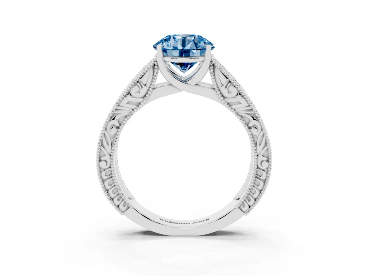 Fancy Blue Round Cut Diamond Solitaire Ring with Engraved Band and Four-Prong Setting White gold