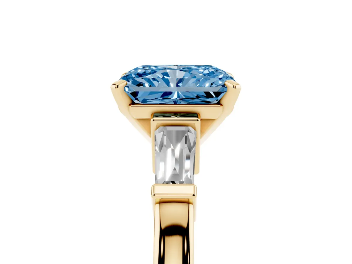 Fancy Blue Radiant Cut Cut Diamond Solitaire Ring with Tapered Baguette Accents and Four-Prong Setting Yellow gold