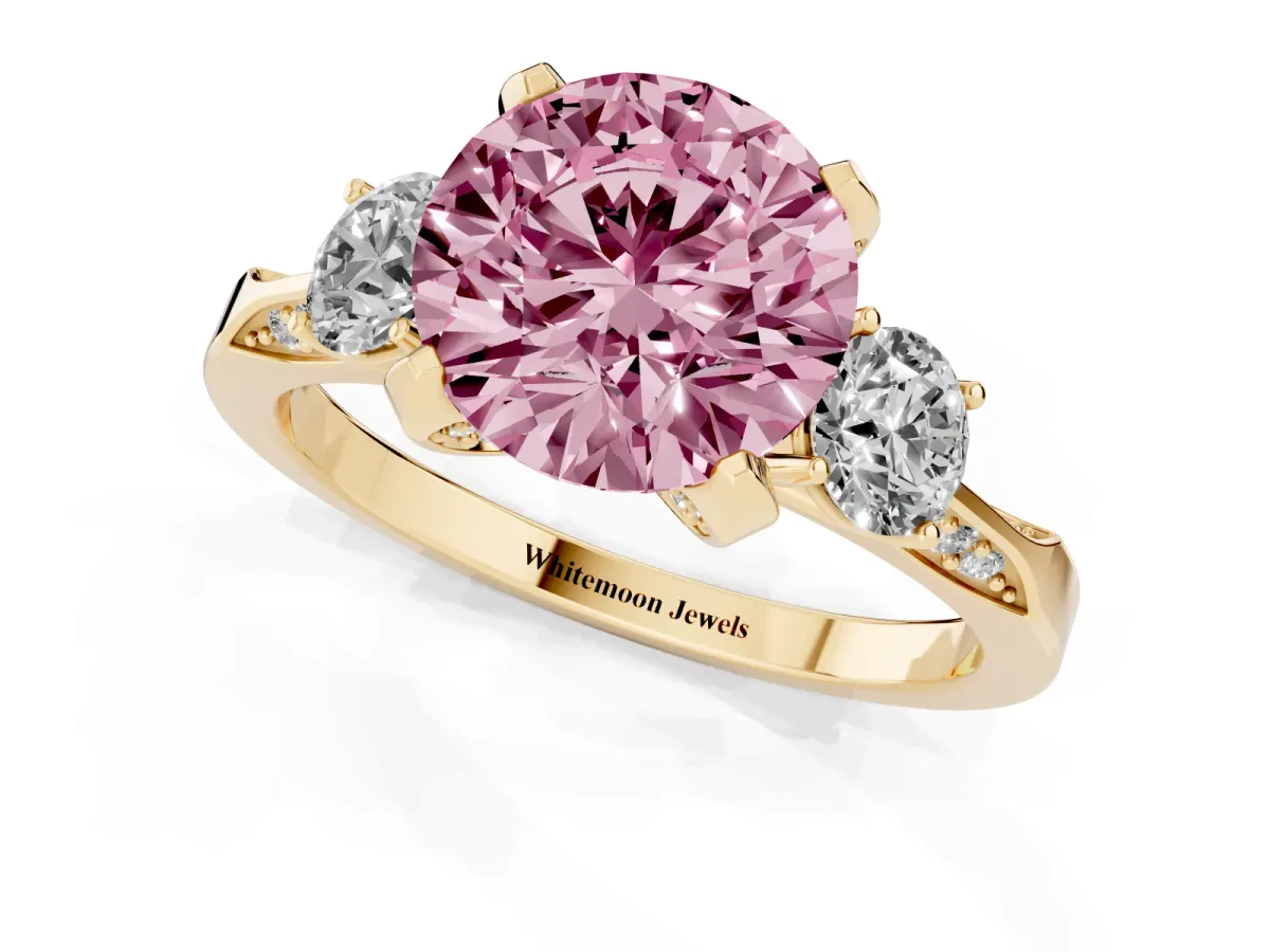Fancy Pink Round Cut Brilliant Three-Stone Diamond Ring with Pavé Band and Four-Prong Setting Yellow gold